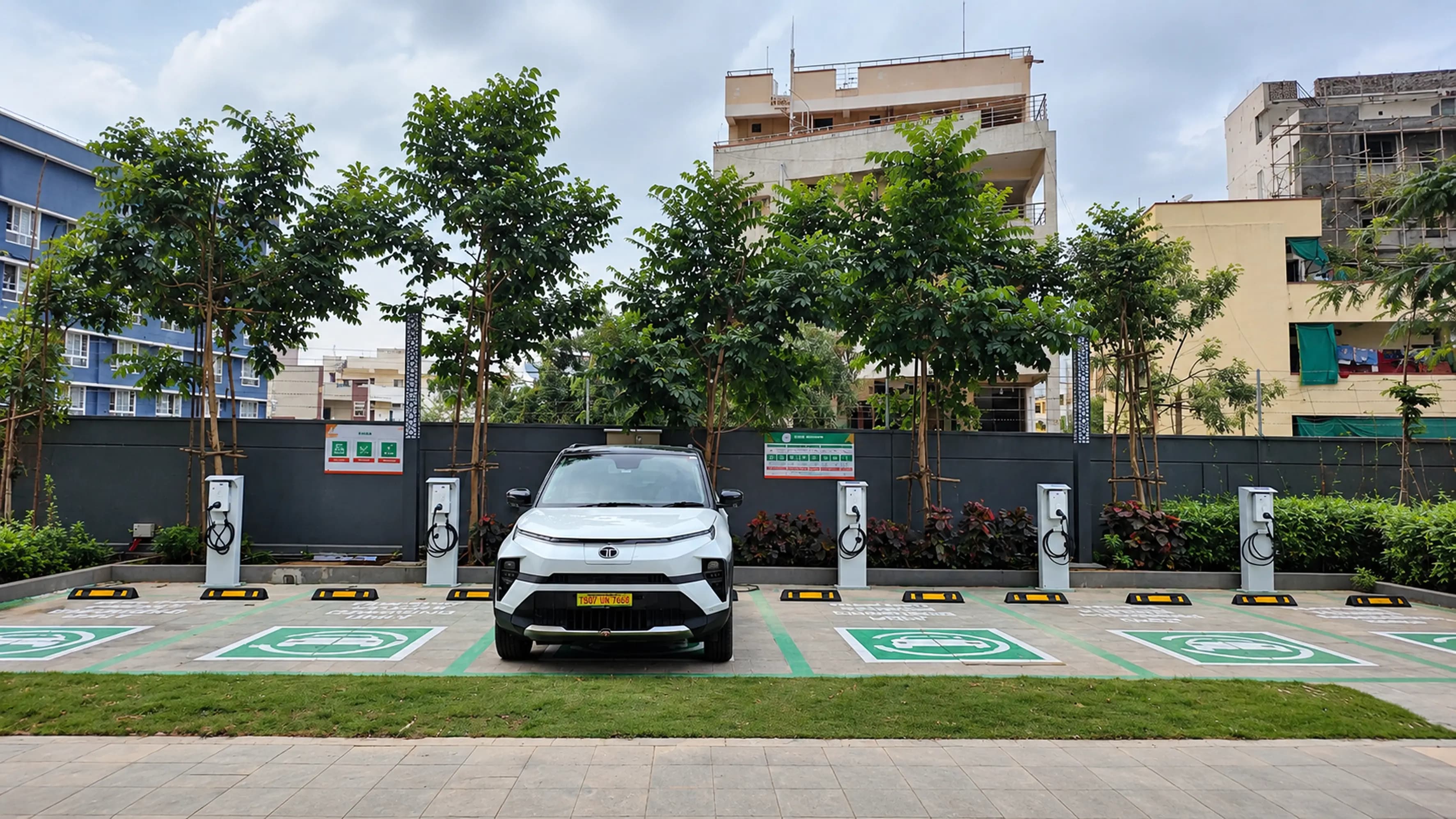 A commercial building forecourt with charging points.