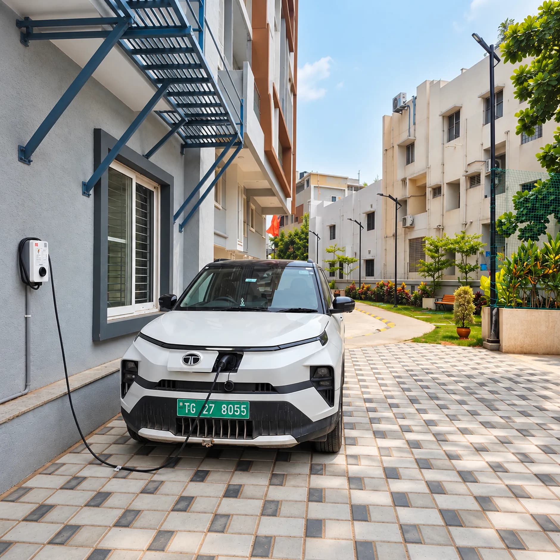 A resident plugging in at a charger outside an apartment block.