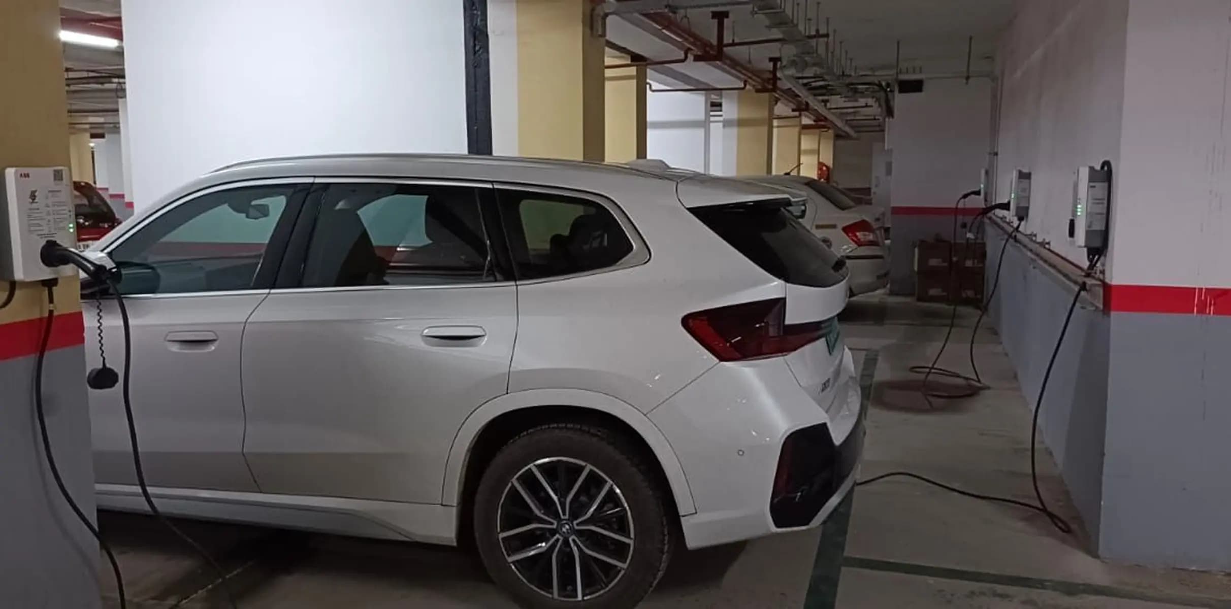 A single LionCharge EV charger installed and charging a vehicle.